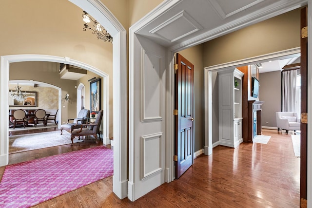 7N230 Sims Ln, Saint Charles, IL 60175 - hall with arched walkways, a chandelier, and wood finished floors