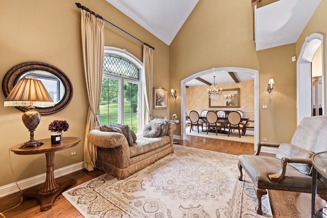 7N230 Sims Ln, Saint Charles, IL 60175 - living area featuring arched walkways, a chandelier, wood finished floors, and high vaulted ceiling