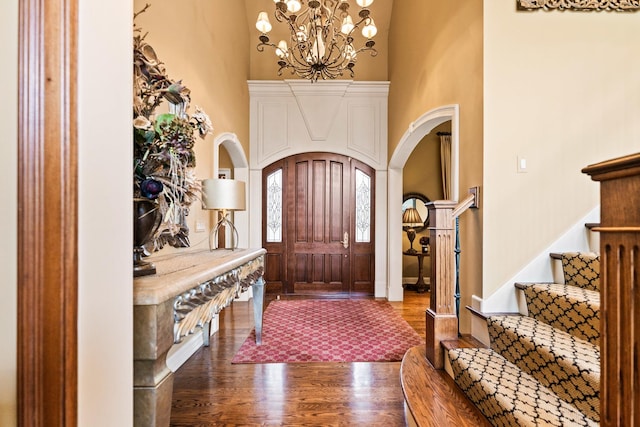 7N230 Sims Ln, Saint Charles, IL 60175 - entrance foyer with arched walkways, wood finished floors, a chandelier, stairs, and a high ceiling