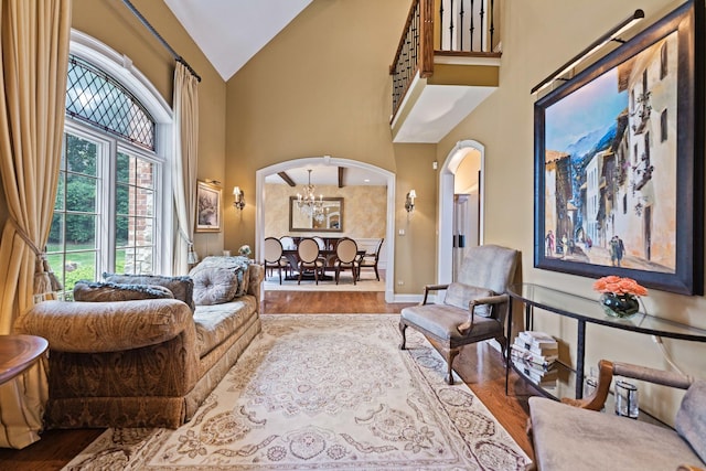 7N230 Sims Ln, Saint Charles, IL 60175 - living area featuring arched walkways, wood finished floors, and high vaulted ceiling