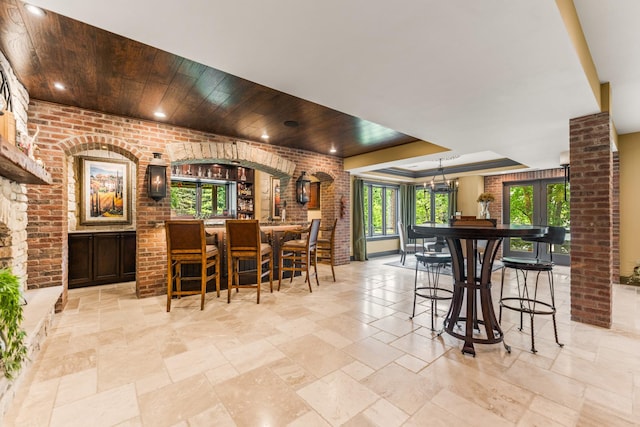 7N230 Sims Ln, Saint Charles, IL 60175 - bar featuring healthy amount of natural light, wood ceiling, brick wall, recessed lighting, and stone tile flooring