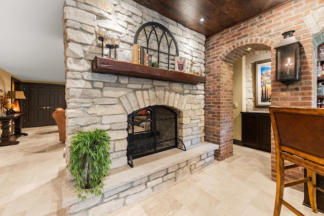7N230 Sims Ln, Saint Charles, IL 60175 - unfurnished living room with wooden ceiling, an outdoor stone fireplace, and stone tile flooring