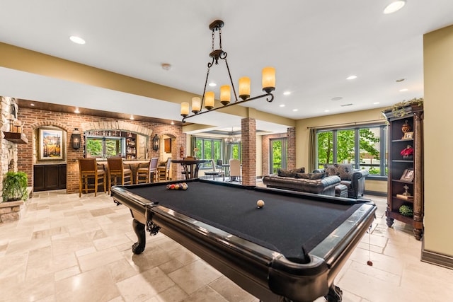 7N230 Sims Ln, Saint Charles, IL 60175 - playroom featuring billiards, a bar, brick wall, stone tile floors, and plenty of natural light