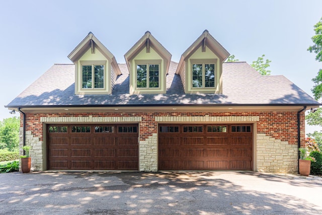 7N230 Sims Ln, Saint Charles, IL 60175 - view of front of house featuring stone siding, a garage, brick siding, and a shingled roof