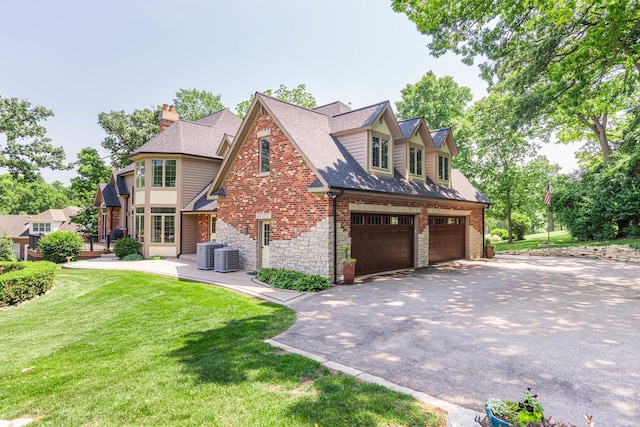 7N230 Sims Ln, Saint Charles, IL 60175 - view of side of property with driveway, a yard, an attached garage, roof with shingles, and a chimney