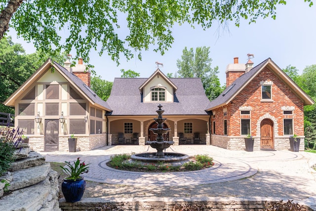 7N230 Sims Ln, Saint Charles, IL 60175 - view of front facade featuring stone siding, a chimney, and a shingled roof