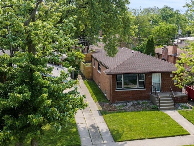 15035 Evers St, Dolton, IL 60419 - view of front of home with brick siding, a shingled roof, and a front yard