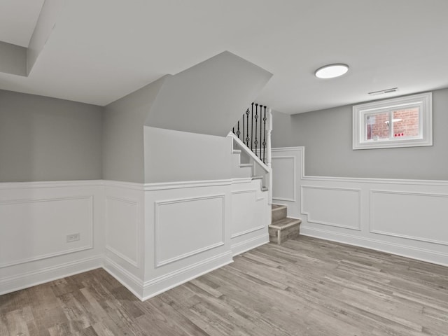 15035 Evers St, Dolton, IL 60419 - stairs featuring wood finished floors, a decorative wall, and a wainscoted wall