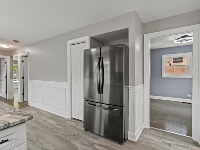 15035 Evers St, Dolton, IL 60419 - kitchen featuring freestanding refrigerator, light wood-type flooring, a wainscoted wall, and light stone countertops