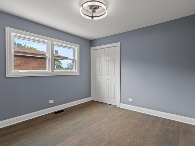15035 Evers St, Dolton, IL 60419 - unfurnished bedroom featuring dark wood-style flooring and a closet
