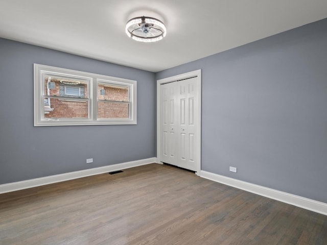 15035 Evers St, Dolton, IL 60419 - unfurnished bedroom featuring dark wood-style floors and a closet