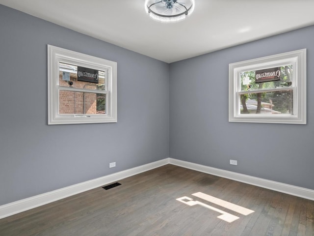 15035 Evers St, Dolton, IL 60419 - unfurnished room with healthy amount of natural light and dark wood finished floors
