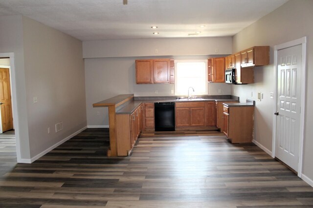 16666 Carle Springs Rd, Wapella, IL 61777 - kitchen with black dishwasher, dark wood-style floors, and a peninsula