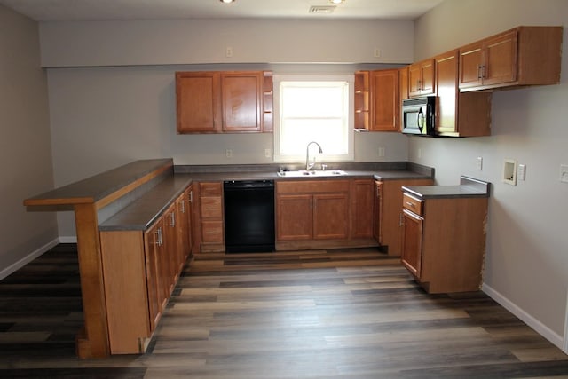 16666 Carle Springs Rd, Wapella, IL 61777 - kitchen with black appliances, a peninsula, brown cabinetry, and dark countertops