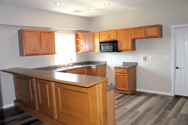 16666 Carle Springs Rd, Wapella, IL 61777 - kitchen featuring a peninsula, black microwave, dark wood-style flooring, brown cabinets, and open shelves