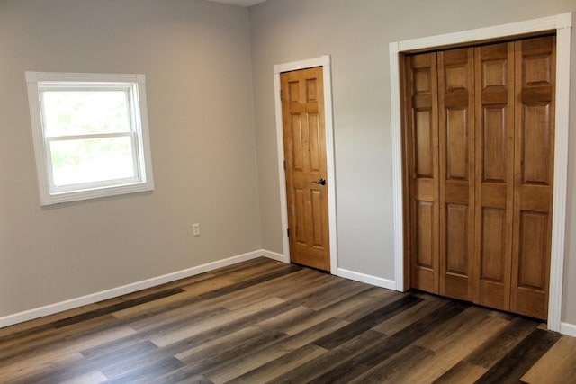 16666 Carle Springs Rd, Wapella, IL 61777 - unfurnished bedroom with dark wood-type flooring and baseboards