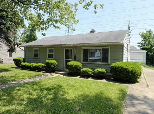 300 Notre Dame Ave, Joliet, IL 60436 - bungalow with a front lawn and a chimney