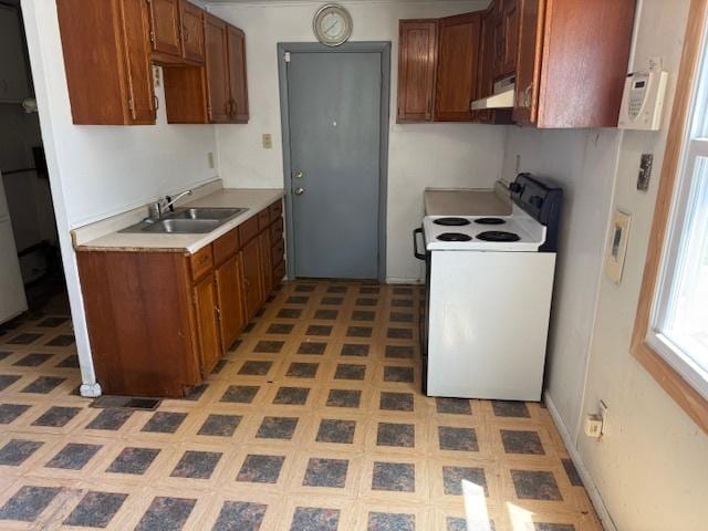 300 Notre Dame Ave, Joliet, IL 60436 - kitchen with electric stove, extractor fan, light countertops, light floors, and brown cabinetry