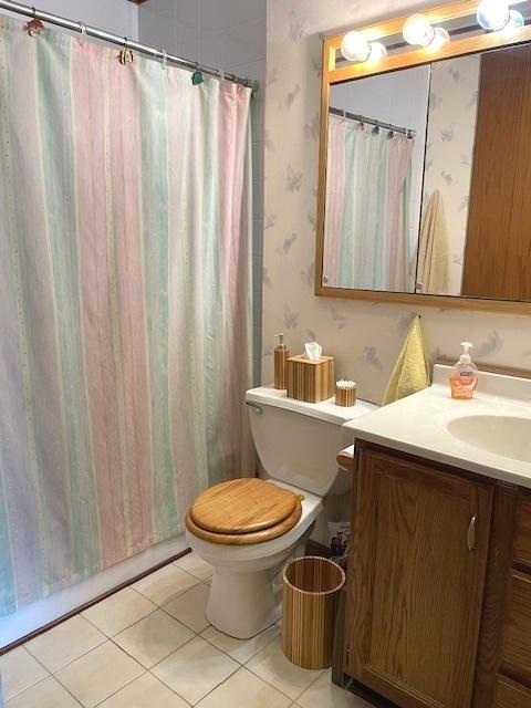 6700 S Brainard Ave Unit 223, Countryside, IL 60525 - bathroom featuring vanity, wallpapered walls, tile patterned flooring, and curtained shower