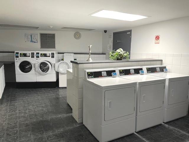 6700 S Brainard Ave Unit 223, Countryside, IL 60525 - community laundry room with washing machine and dryer and tile walls