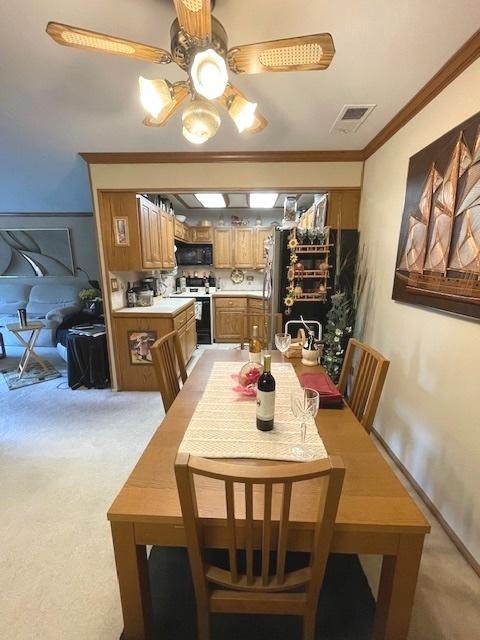 6700 S Brainard Ave Unit 223, Countryside, IL 60525 - dining room featuring a ceiling fan, crown molding, and light colored carpet