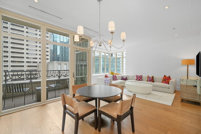 118 E Erie St Unit 14B, Chicago, IL 60611 - dining room with wood finished floors, a chandelier, recessed lighting, and crown molding