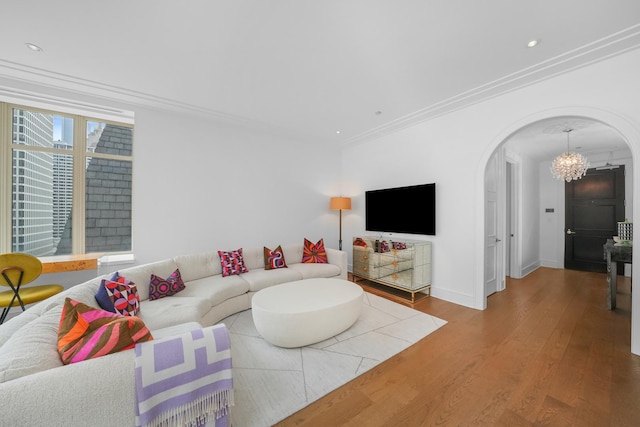 118 E Erie St Unit 14B, Chicago, IL 60611 - living area featuring arched walkways, crown molding, a chandelier, wood finished floors, and recessed lighting