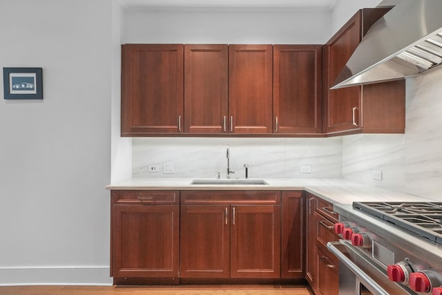 118 E Erie St Unit 14B, Chicago, IL 60611 - kitchen with wall chimney exhaust hood, light countertops, decorative backsplash, high end range, and ornamental molding