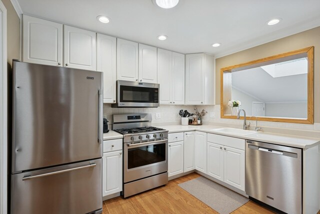 661 E Clarendon Ct, Arlington Heights, IL 60004 - kitchen with stainless steel appliances, light countertops, white cabinets, tasteful backsplash, and recessed lighting