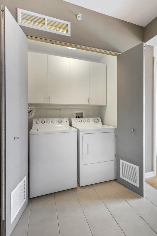 530 N Lake Shore Dr Unit 2408, Chicago, IL 60611 - washroom with washing machine and dryer, cabinet space, and light tile patterned floors