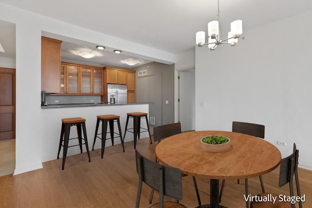 530 N Lake Shore Dr Unit 2408, Chicago, IL 60611 - dining space with a chandelier and light wood finished floors