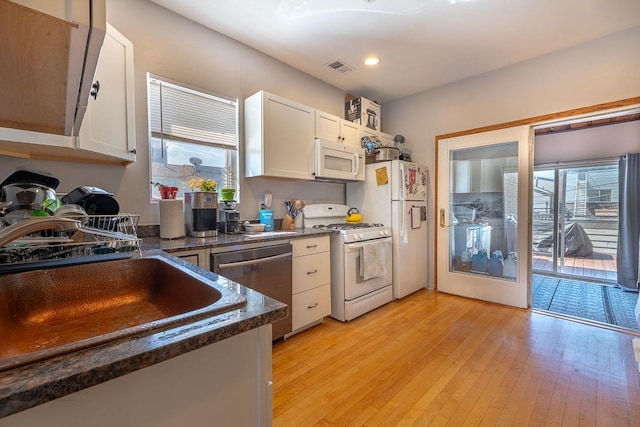 530 N Ashland Ave, Chicago, IL 60622 - kitchen with white appliances, white cabinets, light wood finished floors, and recessed lighting