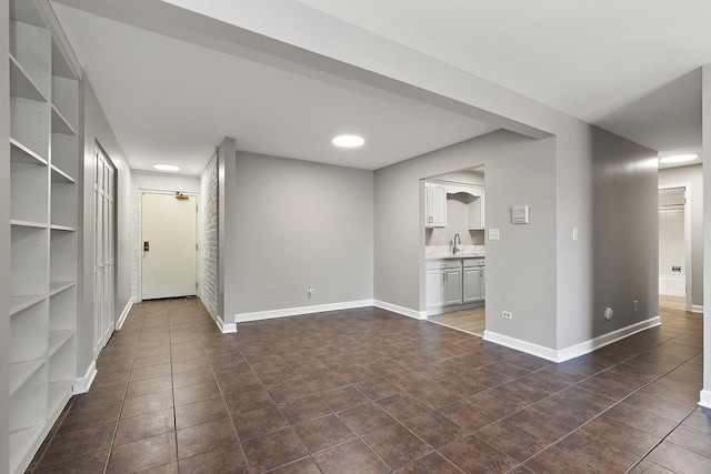 254 E Bailey Rd Unit M, Naperville, IL 60565 - unfurnished living room featuring a sink and dark tile patterned flooring