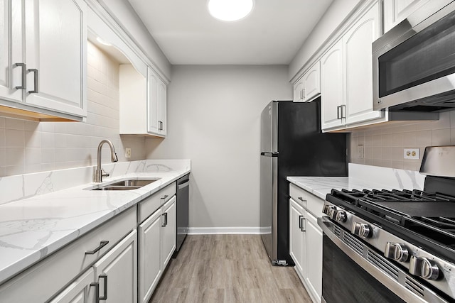 254 E Bailey Rd Unit M, Naperville, IL 60565 - kitchen with appliances with stainless steel finishes, white cabinetry, light wood-type flooring, and tasteful backsplash