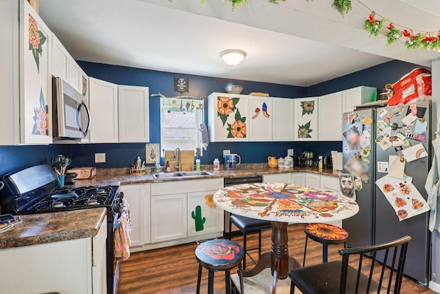 9 Arlington Rd, Fox Lake, IL 60020 - kitchen featuring freestanding refrigerator, black gas range oven, stainless steel microwave, and white cabinetry