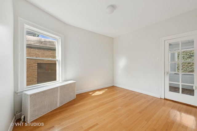6208 N Artesian Ave, Chicago, IL 60659 - unfurnished room featuring radiator and wood finished floors