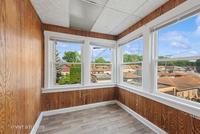 6208 N Artesian Ave, Chicago, IL 60659 - unfurnished sunroom featuring wood walls, plenty of natural light, and wood finished floors