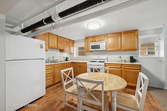 6208 N Artesian Ave, Chicago, IL 60659 - kitchen featuring white appliances, light wood-style floors, light countertops, tasteful backsplash, and plenty of natural light