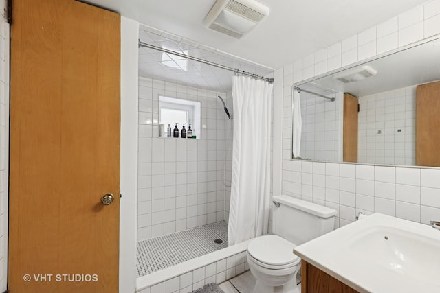 6208 N Artesian Ave, Chicago, IL 60659 - bathroom with tile walls, a tile shower, and vanity