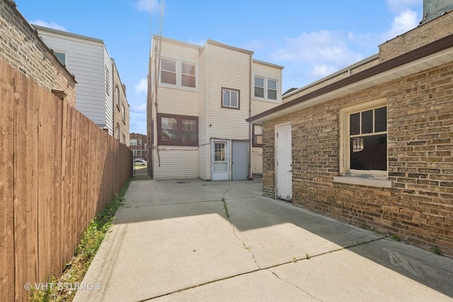 6208 N Artesian Ave, Chicago, IL 60659 - rear view of property featuring a patio area and brick siding