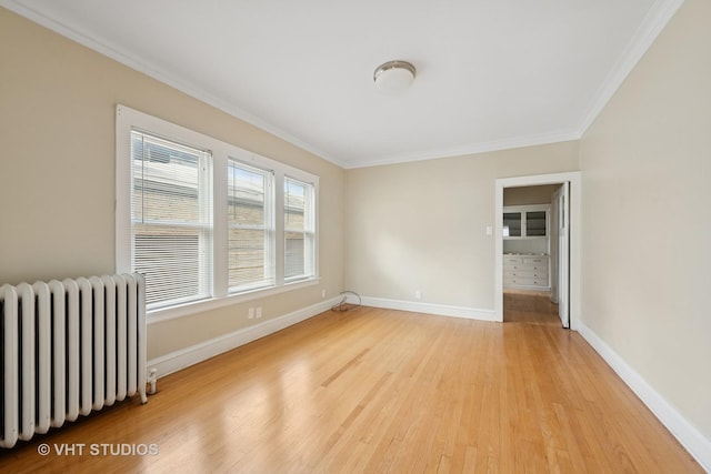 6208 N Artesian Ave, Chicago, IL 60659 - spare room with radiator, ornamental molding, and light wood-style flooring
