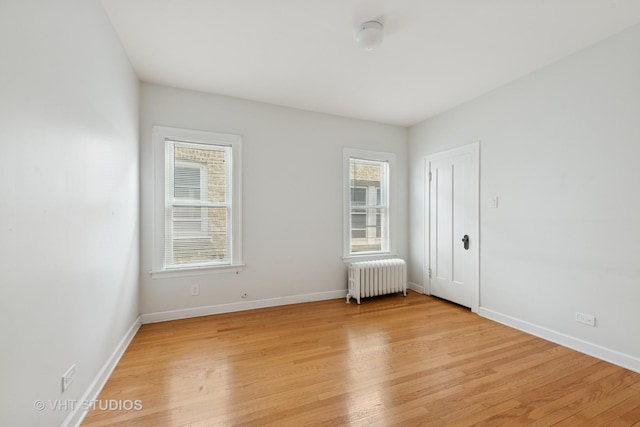 6208 N Artesian Ave, Chicago, IL 60659 - unfurnished room featuring radiator heating unit and light wood-style flooring