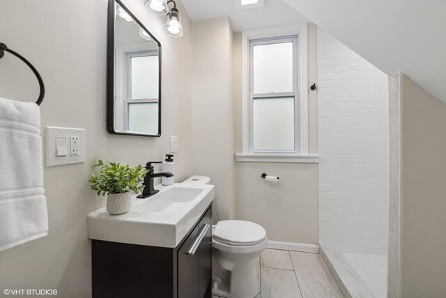 6317 W Cuyler Ave, Chicago, IL 60634 - bathroom with vanity, tiled shower, and marble look tiles