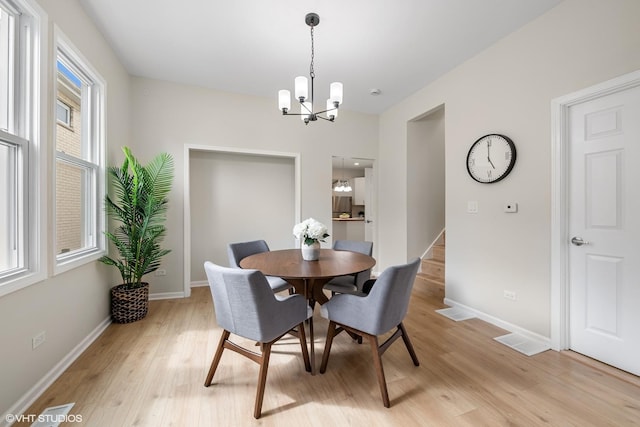 6317 W Cuyler Ave, Chicago, IL 60634 - dining room with a chandelier and light wood-style flooring