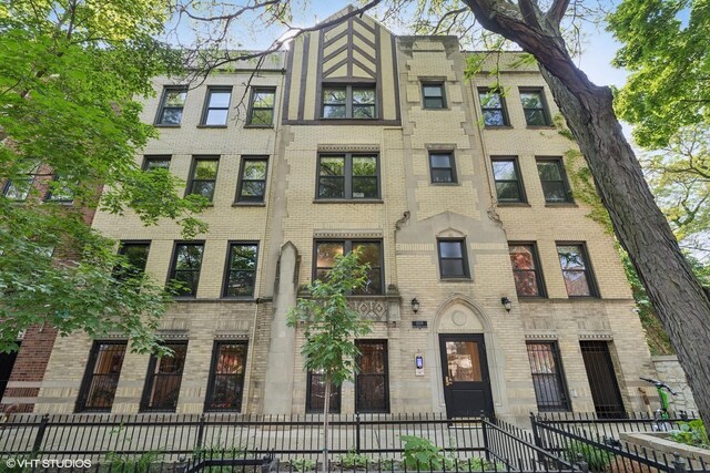 2128 N Hudson Ave Unit 204, Chicago, IL 60614 - townhome / multi-family property with brick siding and a fenced front yard