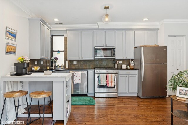 2128 N Hudson Ave Unit 204, Chicago, IL 60614 - kitchen featuring appliances with stainless steel finishes, ornamental molding, a peninsula, tasteful backsplash, and dark wood-style flooring