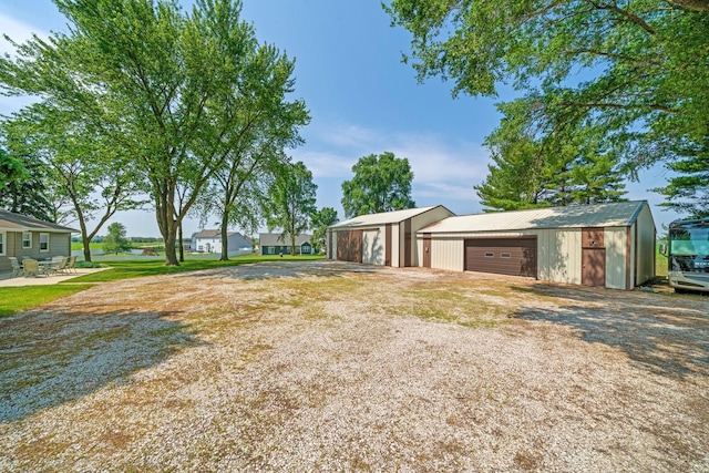 14893 Plank Rd, Sycamore, IL 60178 - view of side of home with a garage and an outdoor structure