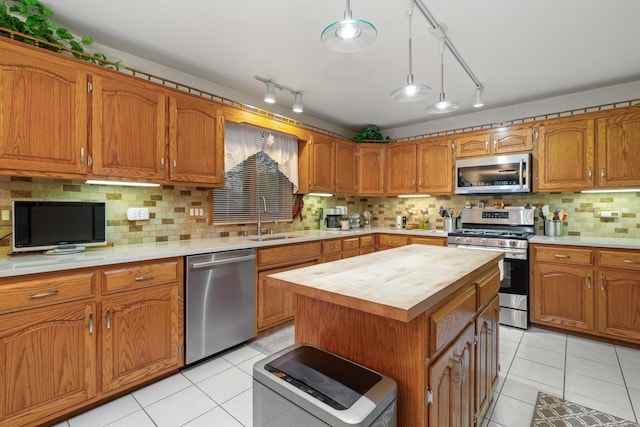 17815 Iroquois, Tinley Park, IL 60477 - kitchen with stainless steel appliances, butcher block counters, light tile patterned floors, and decorative backsplash