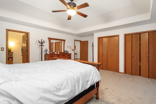 17815 Iroquois, Tinley Park, IL 60477 - bedroom featuring light colored carpet, a tray ceiling, two closets, and a ceiling fan
