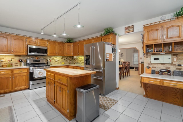 17815 Iroquois, Tinley Park, IL 60477 - kitchen with stainless steel appliances, butcher block counters, light tile patterned floors, tasteful backsplash, and a center island